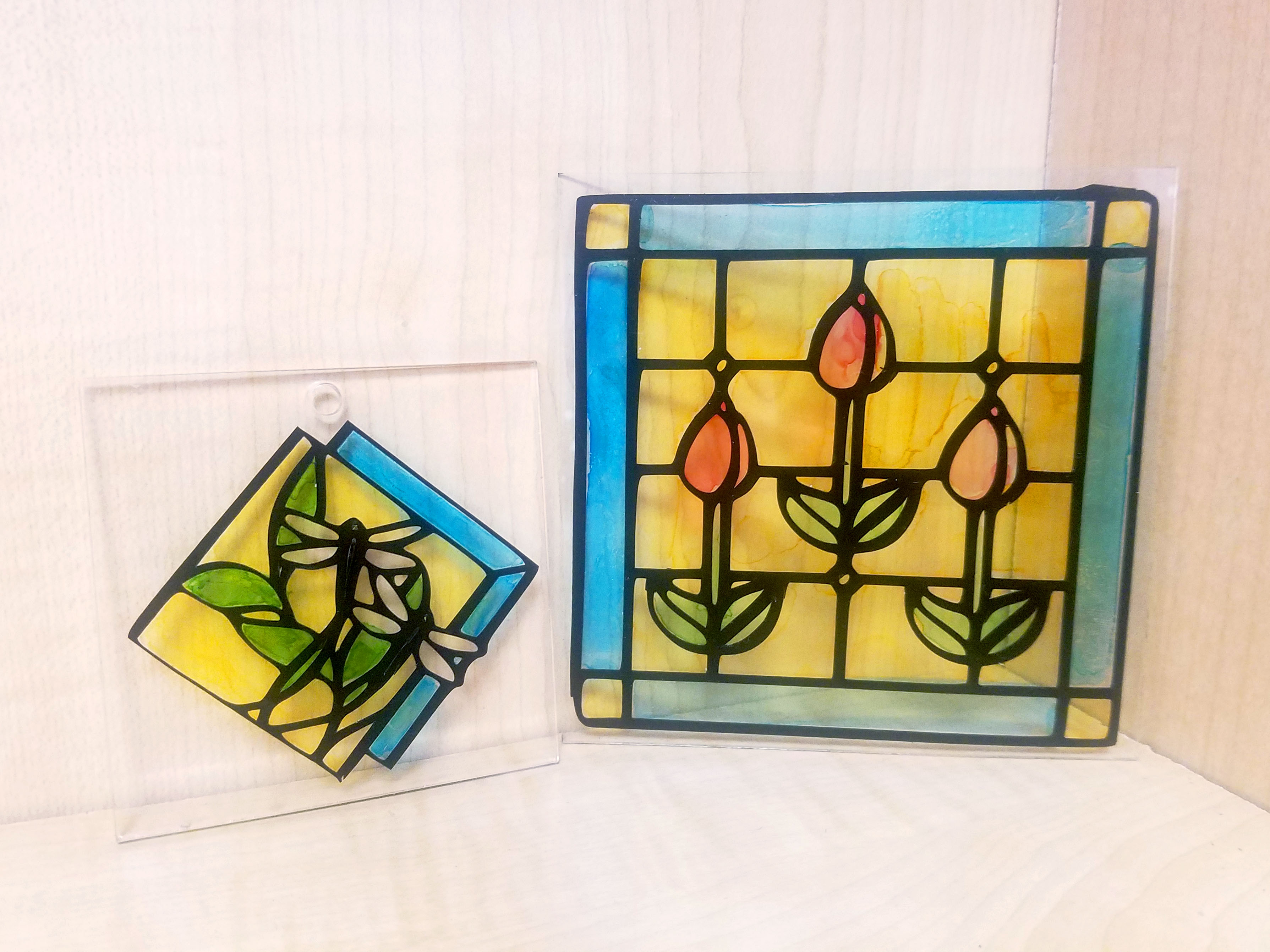 Two faux stained glass projects made with vinyl stickers and artist markers