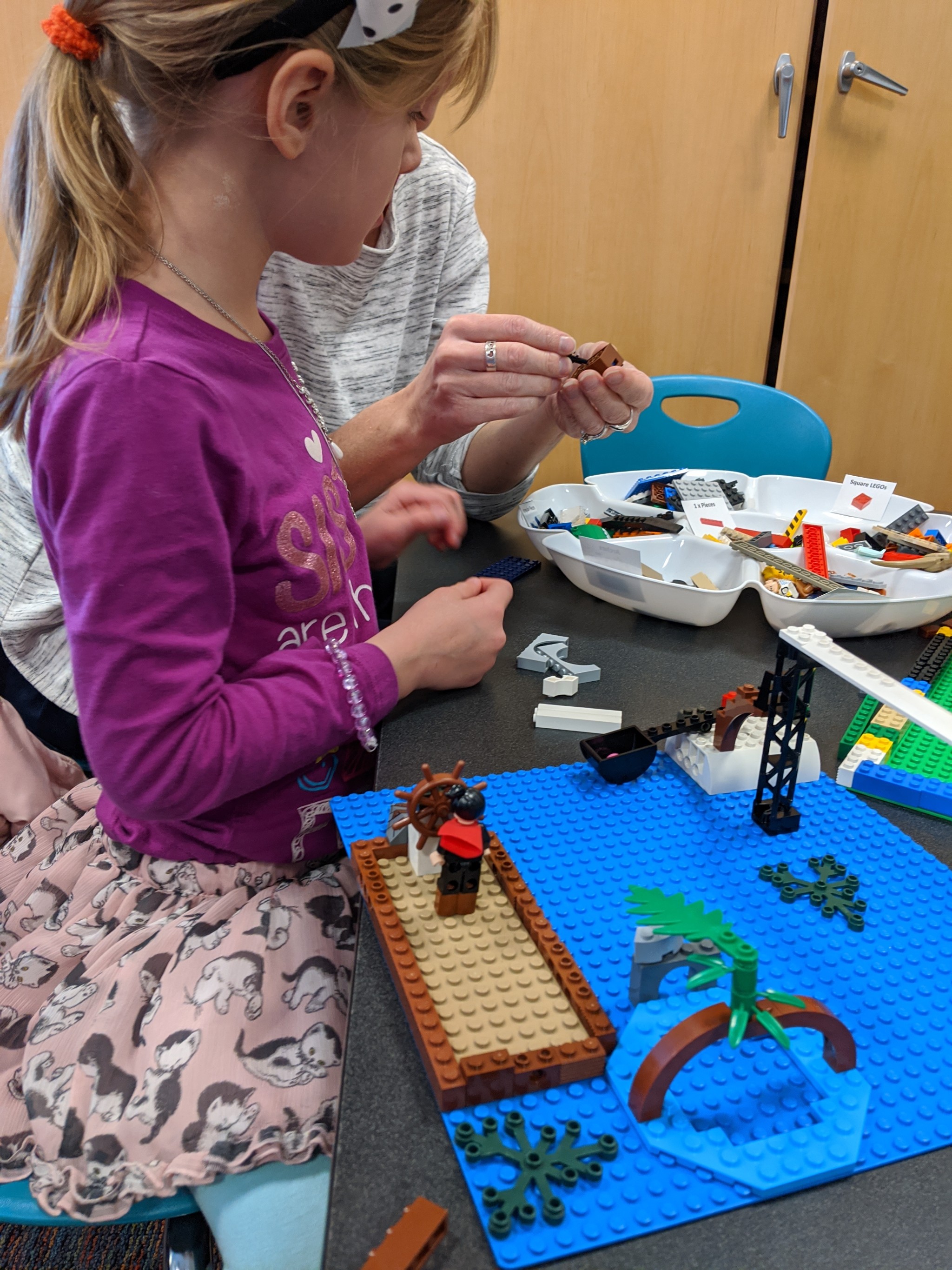 Girl playing with LEGO.