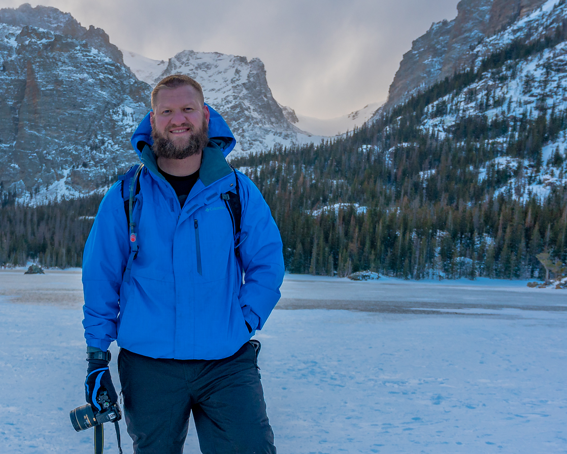 photo of jeremy janus standing in front of snowy mountains