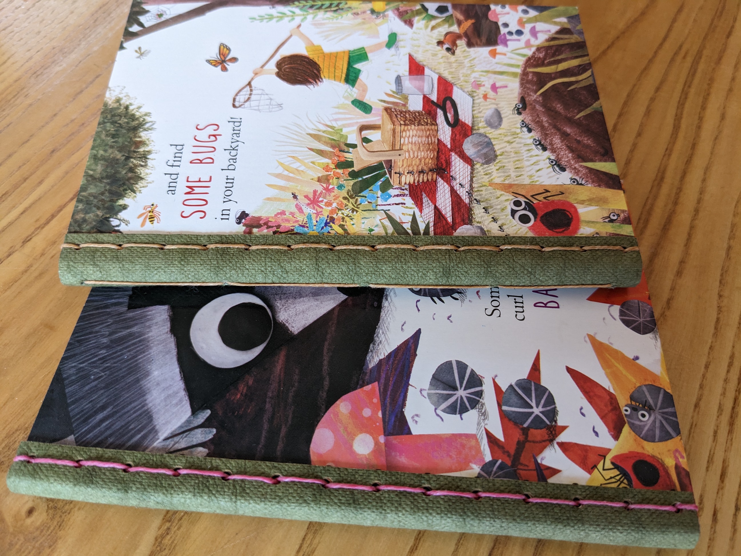 Two journals made from old library board books with Kraft Tex spines. 