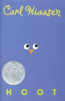 Book cover of Hoot by Carl Hiaasen. The cover is blue. In the center there are two cartoon eyes with an orange beak.