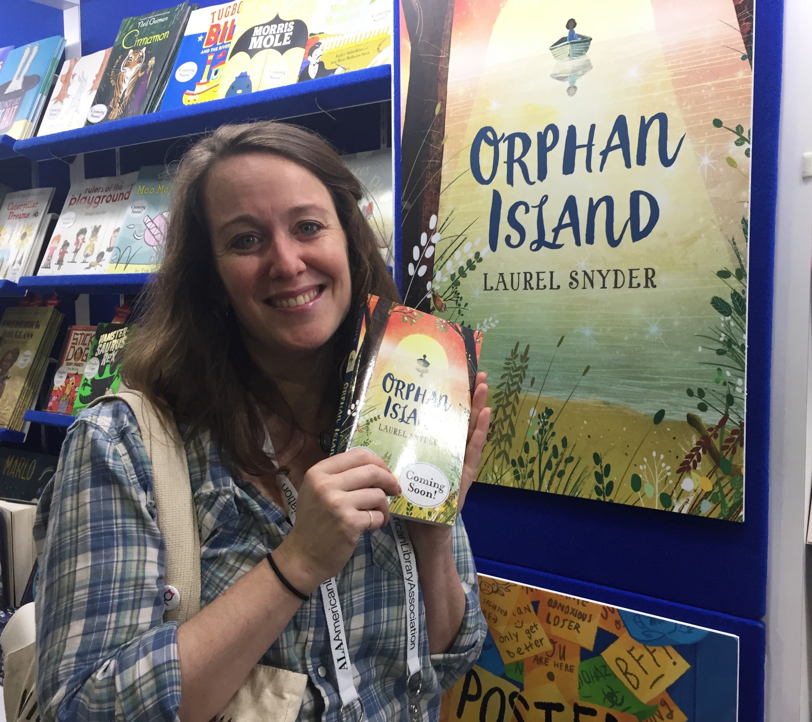 Photo of author Laurel Snyder holding a copy of Orphan Island