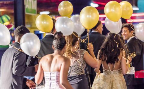 teenagers at prom holding balloons