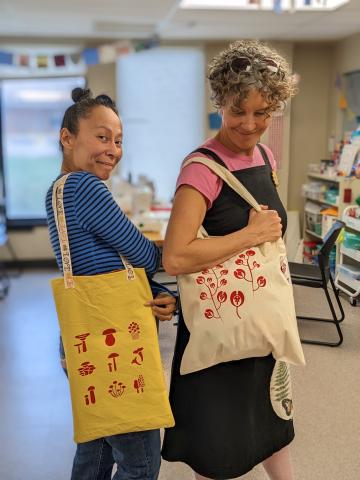 Screen printed tote bags with mushrooms and flowers.