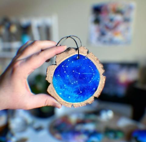 photo of wood slice ornament painted with orion constellation