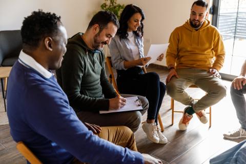 Four adult writers sitting together in group