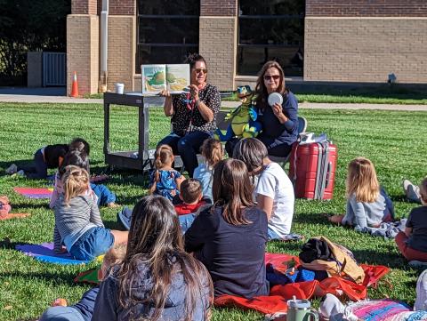 Storytime on the grass with children and storytime presenters.