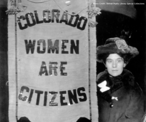 historical photo of woman holding sign reading "colorado women are citizens"