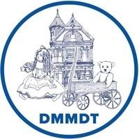 logo of the Denver Museum of Miniatures. Drawing of a victorian house in the background with a doll and bear in a wagon in the forefront