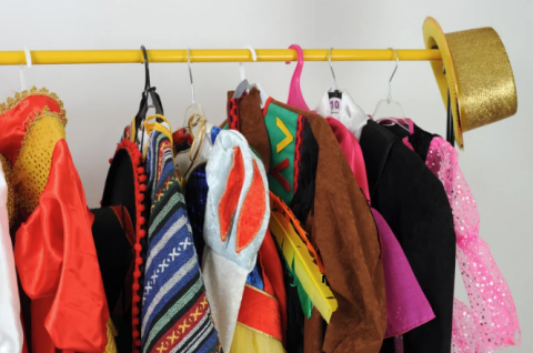 Close up of a clothing rack with Halloween costumes hanging on hangers