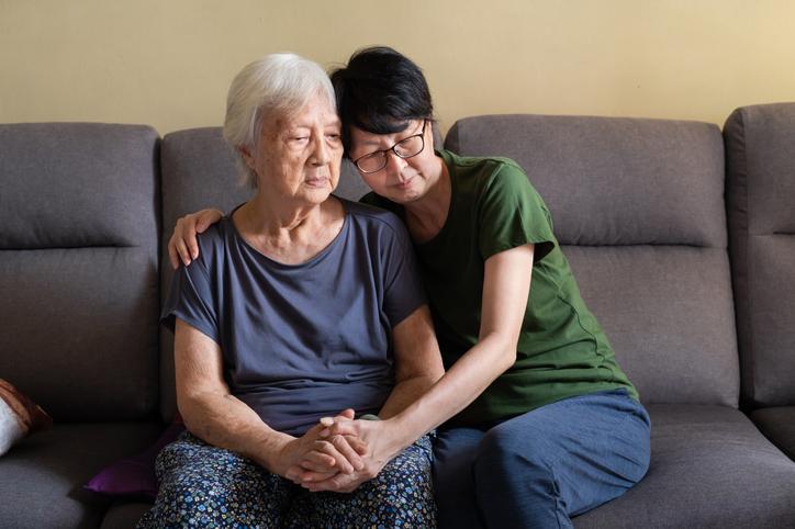 Asian family member spending time with their older relative