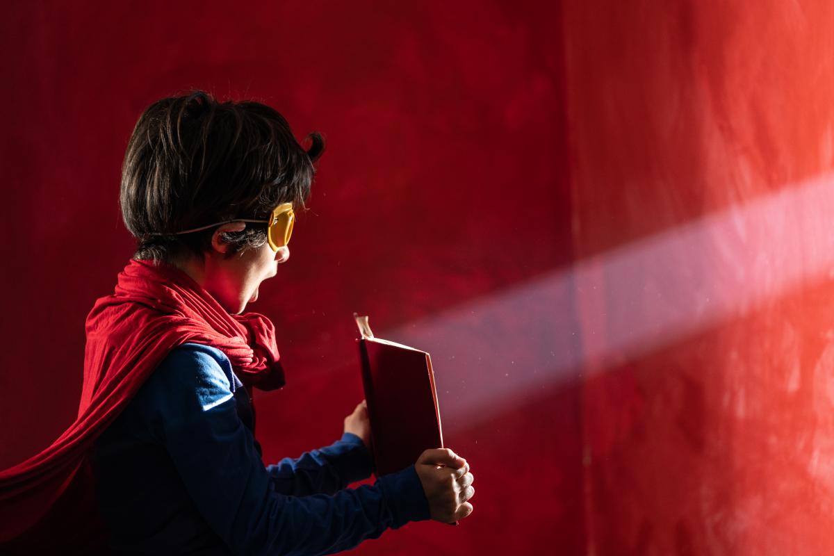 Child in costume with a book.