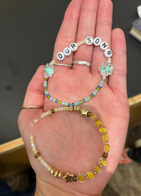 photo of hand holding two friendship bracelets