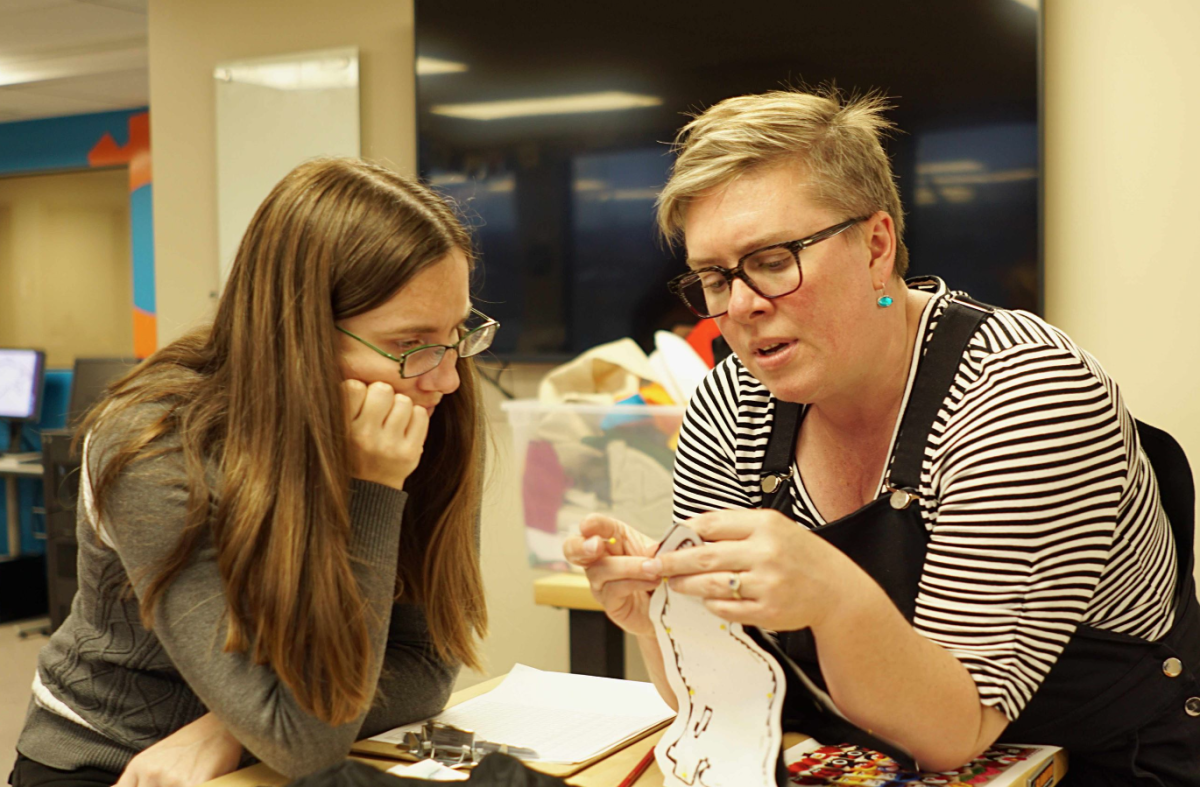 Educator observing a facilitator demonstrating a project technique