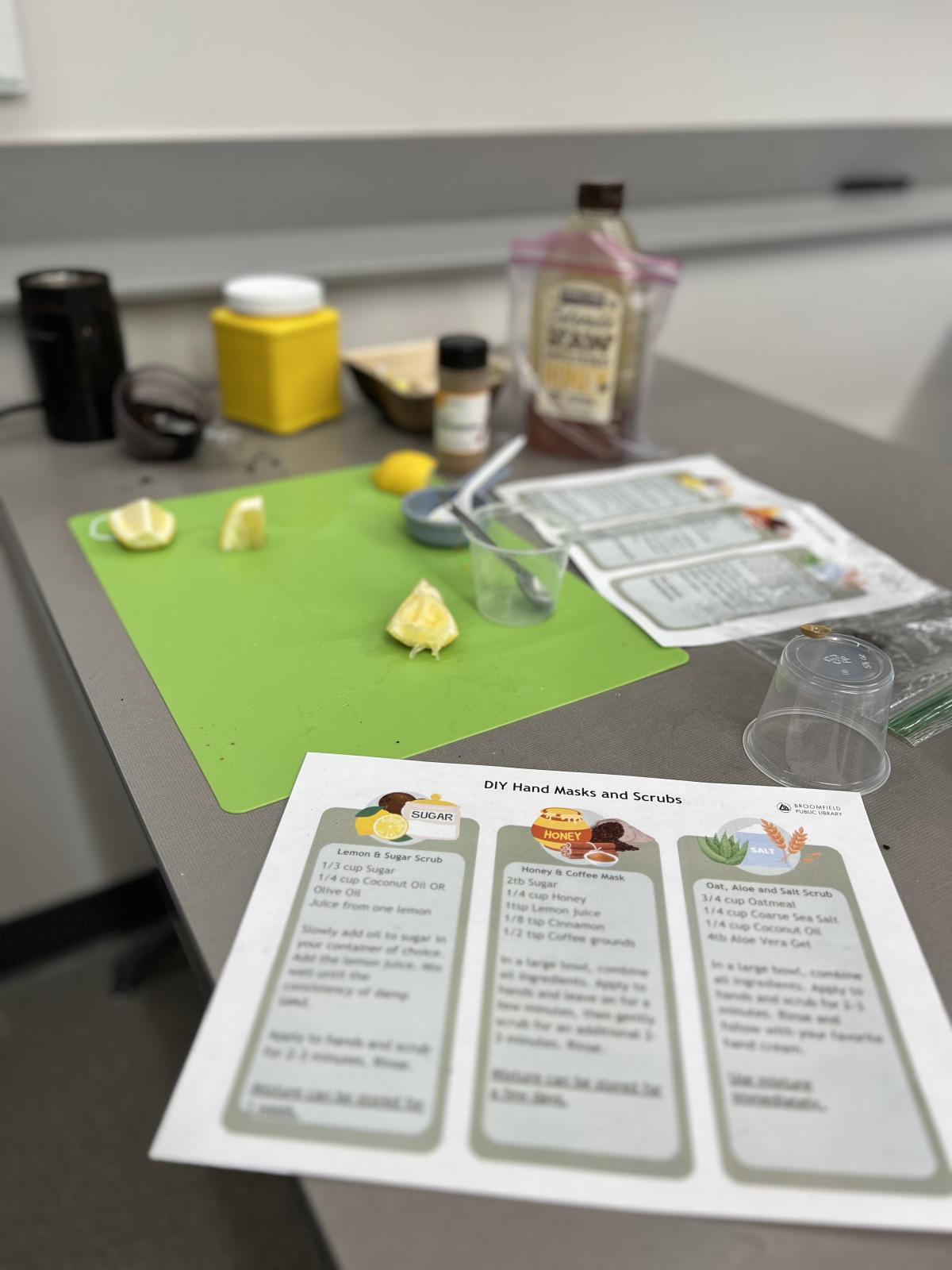 recipes for hand masks and salves printed on paper with cut lemons in the background