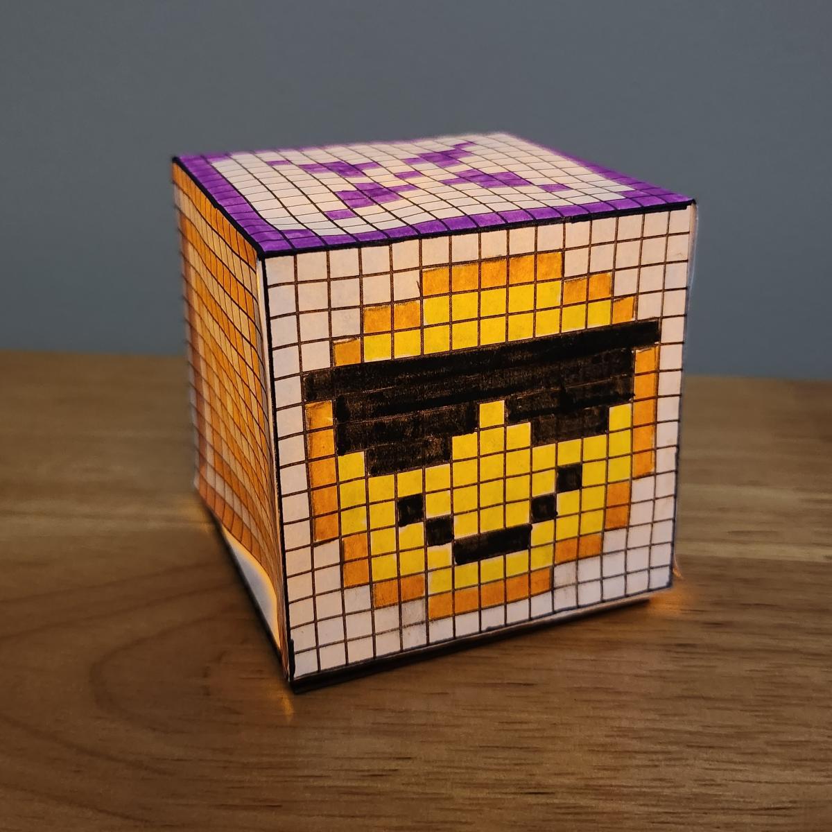 Smiling face with sunglasses pixel art on an illuminated pixel cube