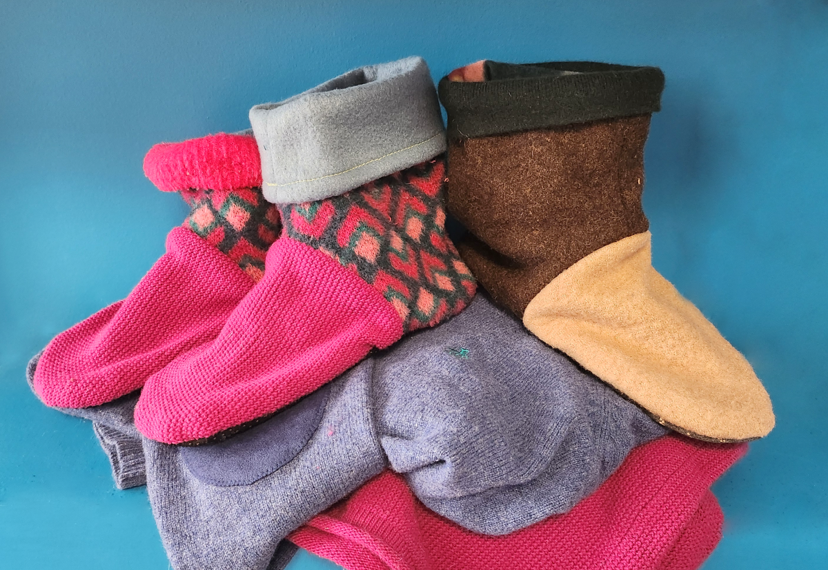 Hand sewn upcycled slipper on top of sweaters