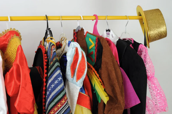 Close up of a clothing rack with Halloween costumes hanging on hangers