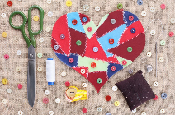 Heart made of scraps of fabric sewn together with button embellishments