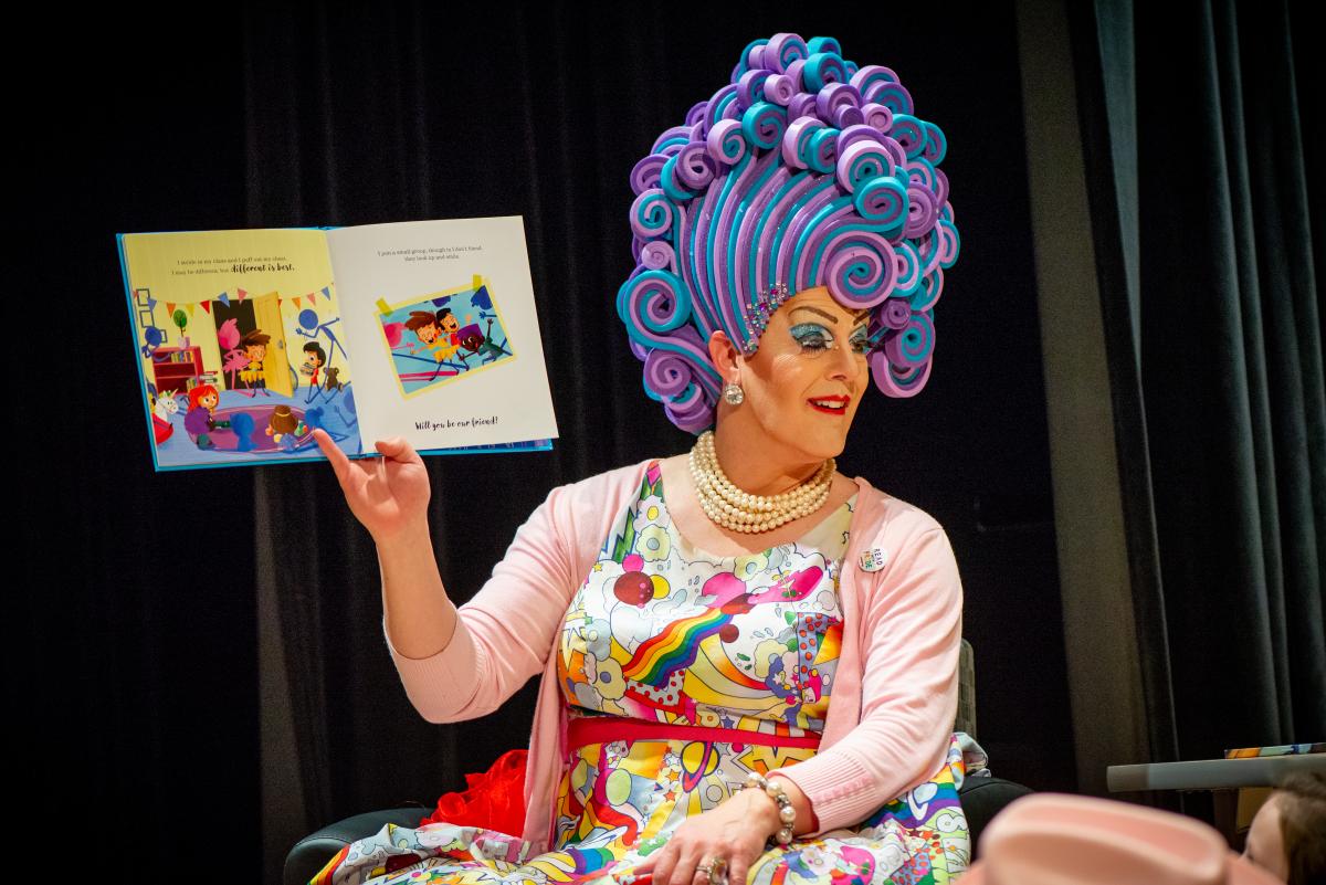 Drag queen reading book aloud